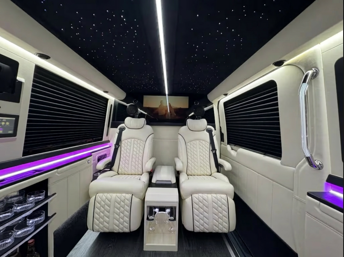 Light-leather cabin with ambient lighting and captain chairs